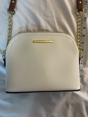 Steve Madden White Crossbody Bag with gold and brown chain.